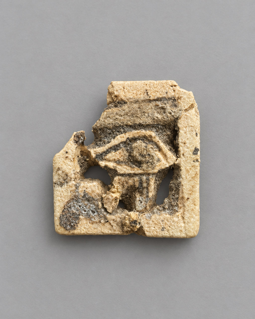 Ancient Egyptian Openwork Wedjat Eye (Eye of Horus) - Cream Faience with Black Manganese Pigment - Third Intermediate Period, c. 1069-664 BC
