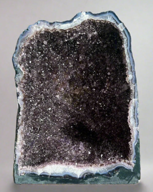 Large Brazilian amethyst cathedral geode with unique natural inclusions.