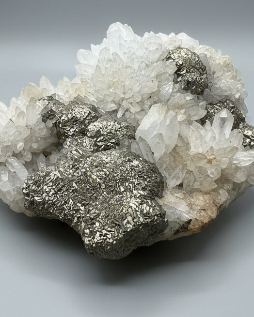 Druzy Cubic Pyrite on Opaque Quartz Cluster. Peru.